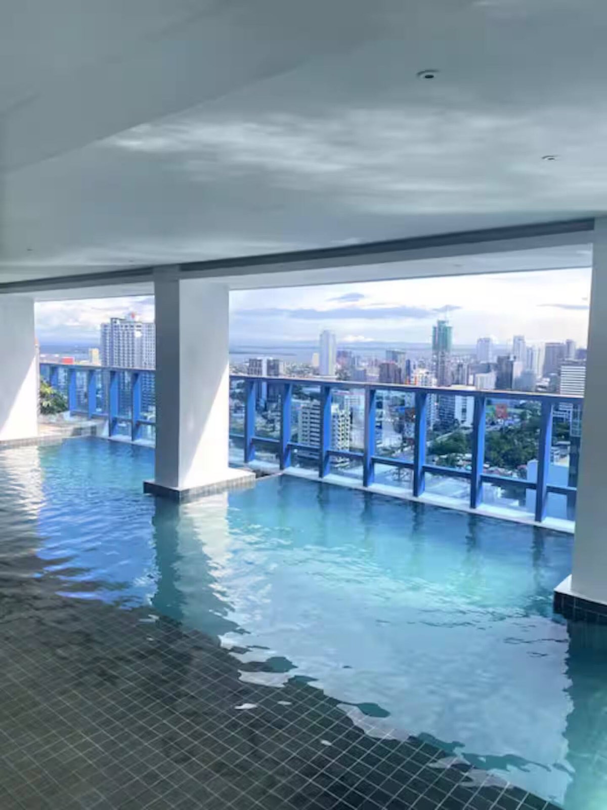 The infinity pool on the amenity deck at 38 Park Avenue, looking out over the Cebu skyline.